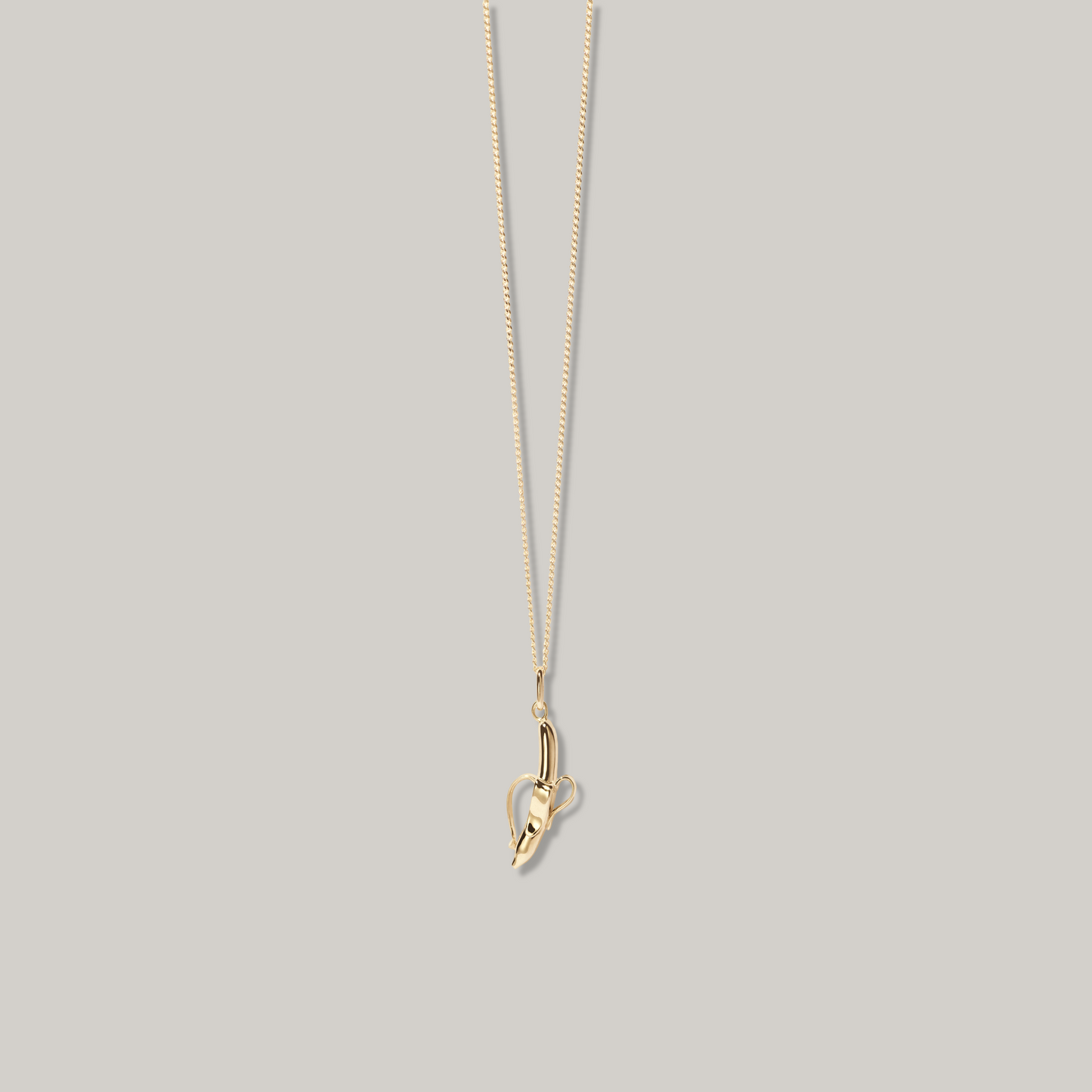 MEADOWLARK BANANA CHARM NECKLACE - 23K GOLD PLATED